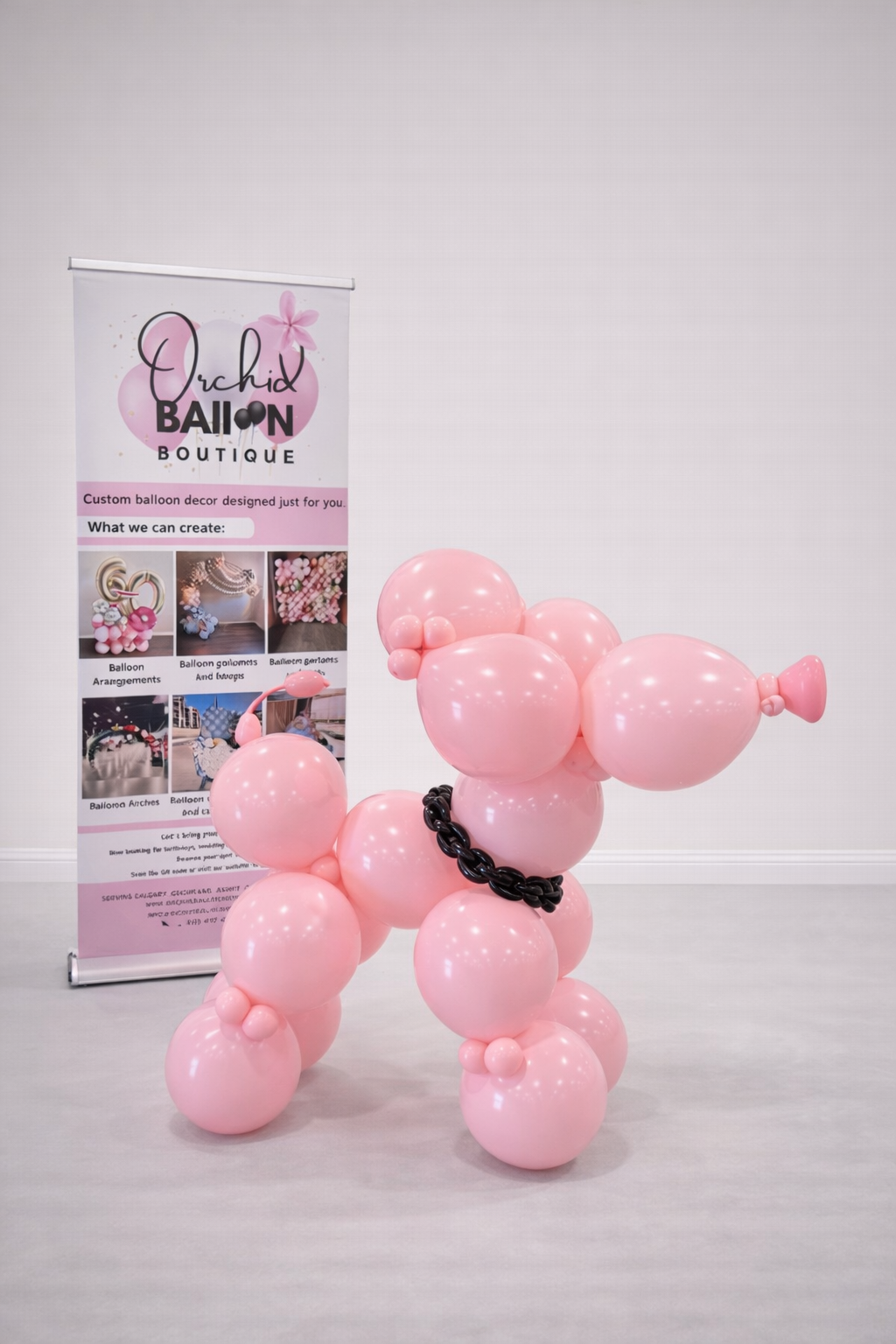 Large pink balloon dog sculpture used as birthday party decor in Calgary.