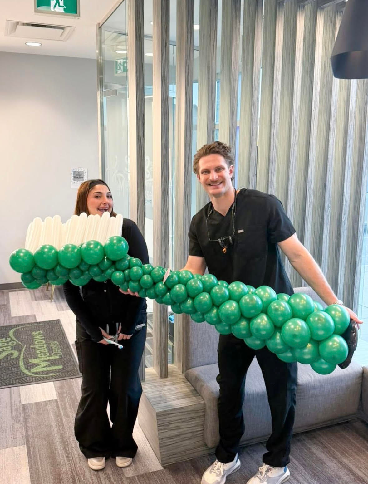 Toothbrush balloon sculpture created for dental clinic event decor in Calgary.