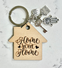 Home sweet Home key chain with charms, Home sweet Home, and other charms.