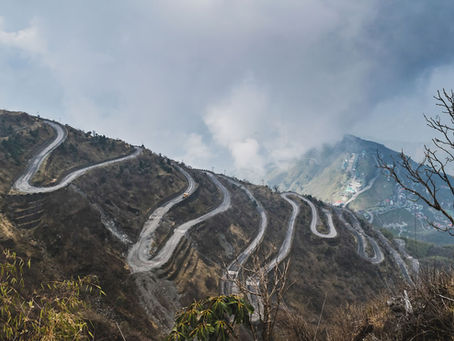 Winding Mountain Path with clouds above