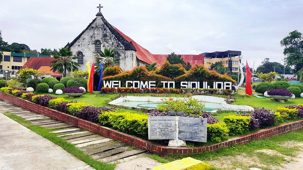 Welcome to Siquijor signage beside the island's historic church — arrival on a CILYC private sailing expedition
