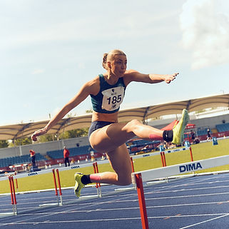 Female sprint hurdler competing for Exeter University at the BUCS Championships