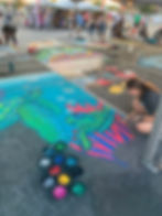 Reilly Moss blending chalk to create a sea turtle piece of art.