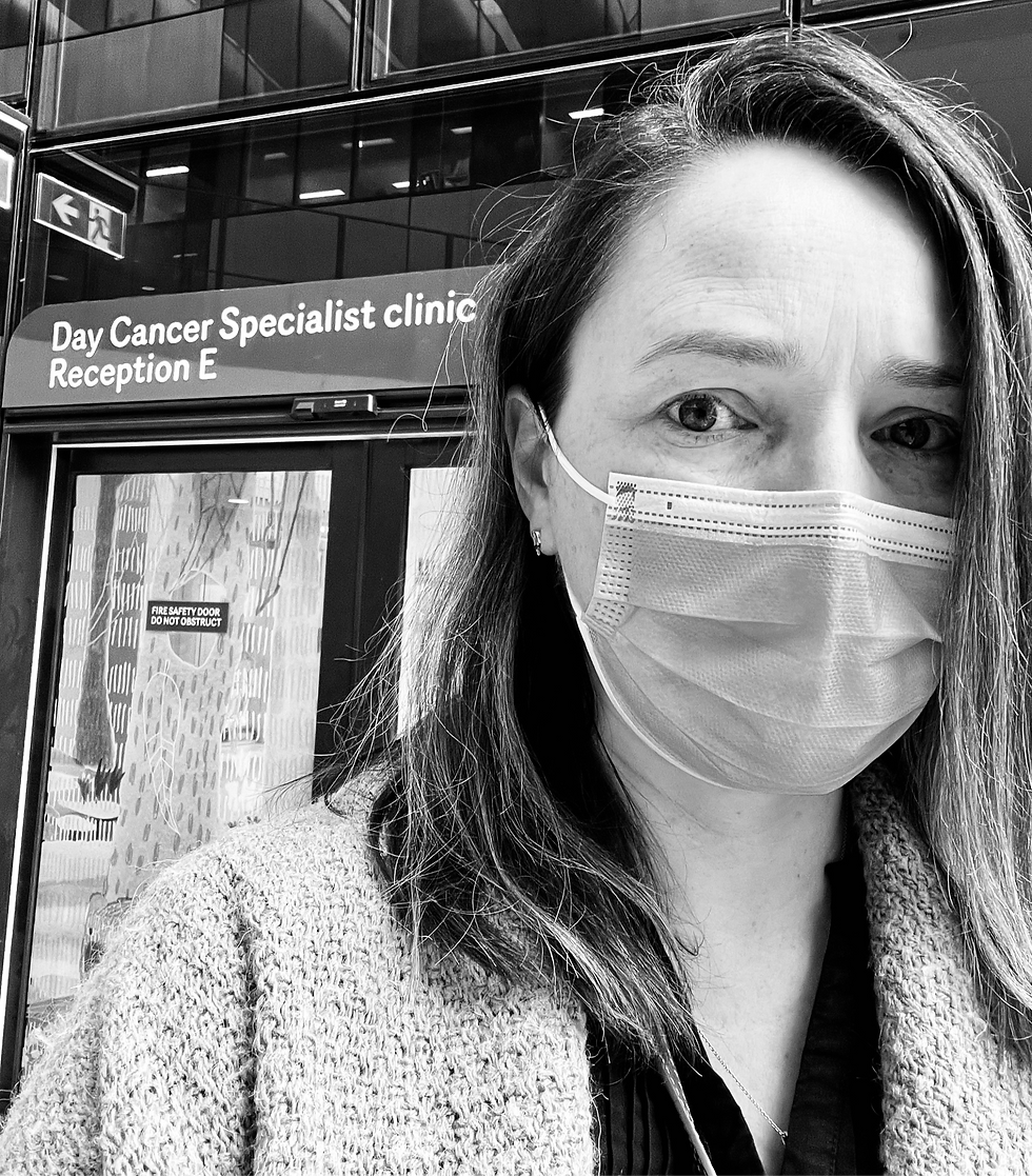 A mother standing in front of her child's cancer clinic door