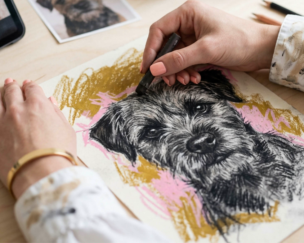 Artist adding charcoal detail to a custom minimalist dog portrait commission, demonstrating the hand-drawn pet portrait process