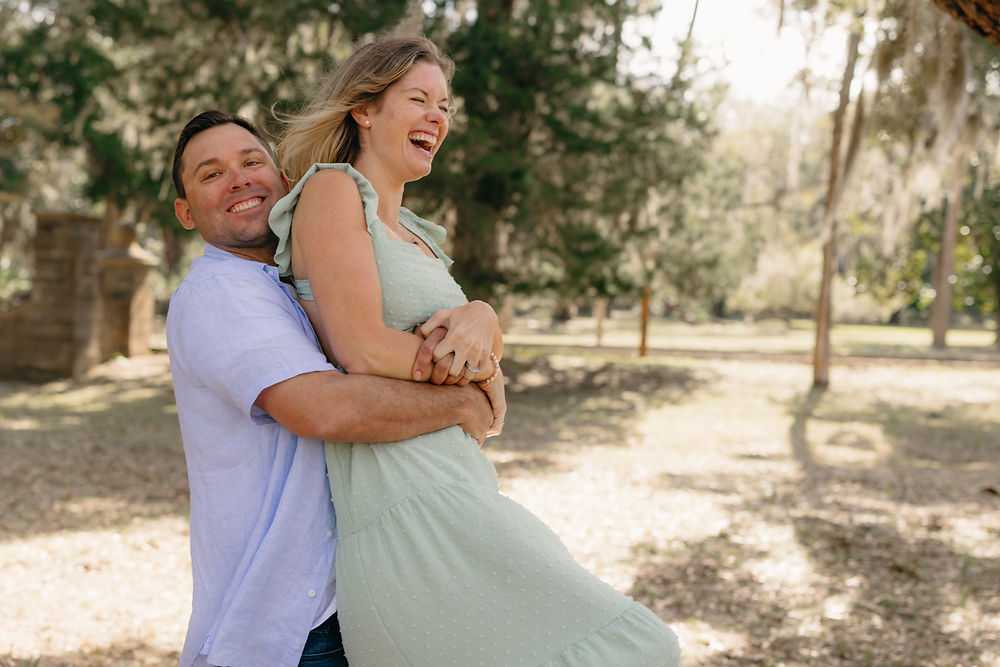 Happy couple laughing and hugging outdoors