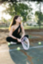 Woman on tennis court with racket, a moment of wellness fitness