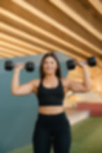 Woman doing dumbbell workout for wellness fitness