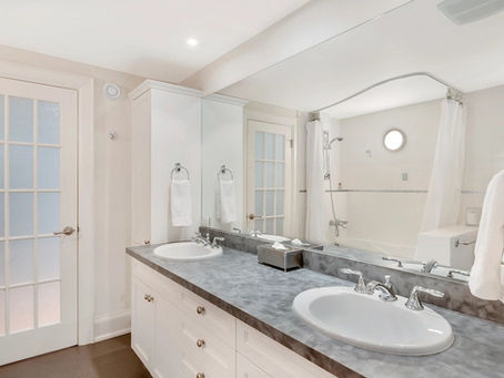 Bathroom renovation in Mississauga with double vanity and tile tub surround