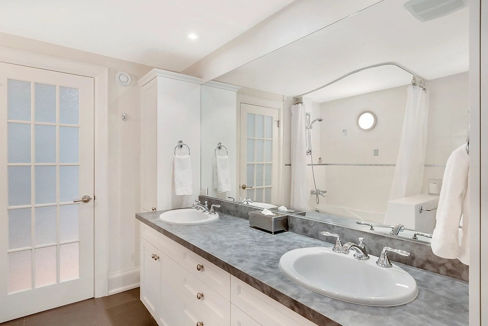 Bathroom renovation in Mississauga with double vanity and tile tub surround