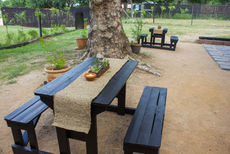 Two rustic outdoor picnic tables