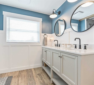 custom designed bathroom with a double vanity, soaker tub, custom tile wall surround with niches, custom trim work to make a beautiful interior renovation
