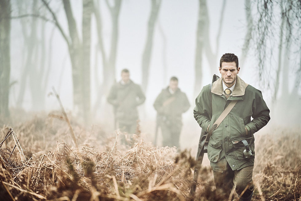 man walking through woods wearing Highland jacket by musto