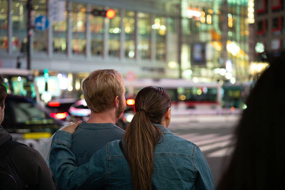 Thumbnail: Couple overlooking a blurred city street at night