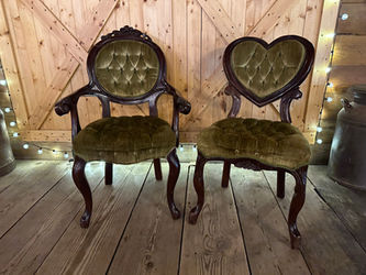 These plush green sweetheart chairs are available for rent at $25 per day each