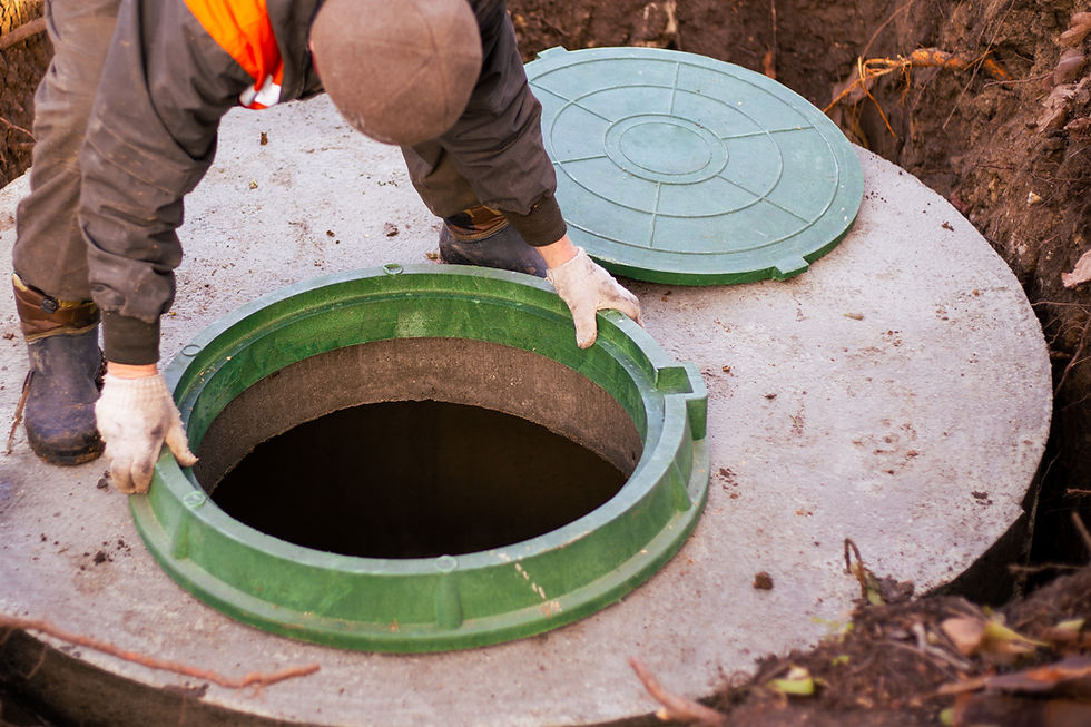 the builder installs a manhole on a concrete sewer well Construction of a septic tank for
