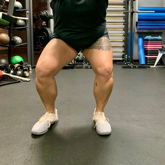 Person doing a right foot out narrow stance squat