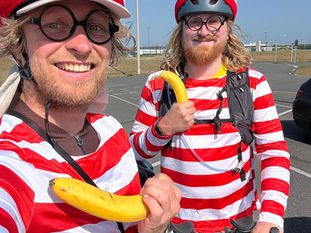 Two people dressed as Wheres Wally, holding bananas