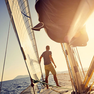 man-standing-on-sail-boat.jpeg