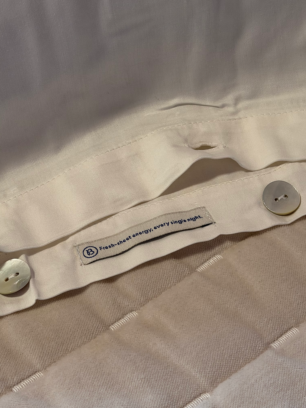 Close-up of Bearaby bamboo sheets showing breathable bamboo viscose fabric and button closure detail for durability and fit.