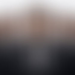 A group of men dressed in black suits with a white background. 