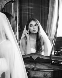 bride seated at vintage vanity during bridal portraits at The Mason Dallas
