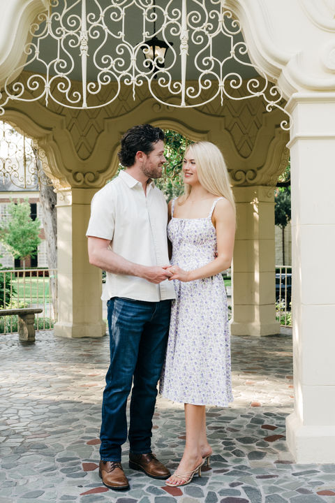 Couple holding hands beneath gazebo at Flippen Park in Dallas.