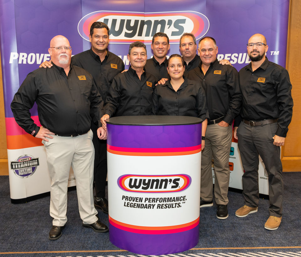 Group of employees posing at Omni Las Colinas corporate event.