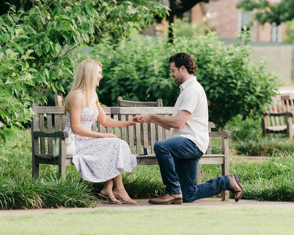 Dallas proposal moment as man puts engagement ring on woman’s hand.
