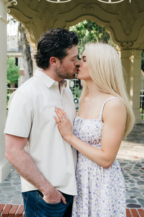 Couple kissing beneath gazebo at Flippen Park engagement session.