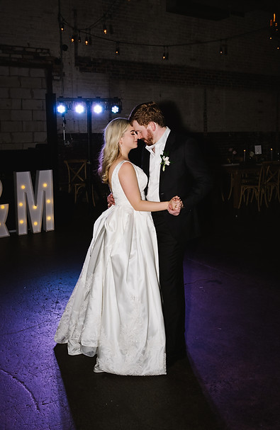 Bride and groom sharing their first dance at Brake & Clutch Warehouse wedding venue in Dallas, Texas