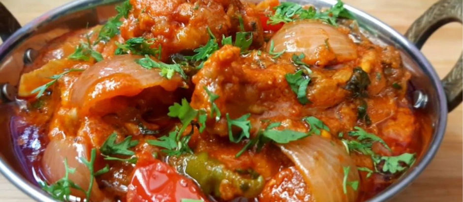 BIR Chicken Dopazia with cilantro, naan, white rice with seeds, and a glass of mint water on a wooden table; cozy dining setting.