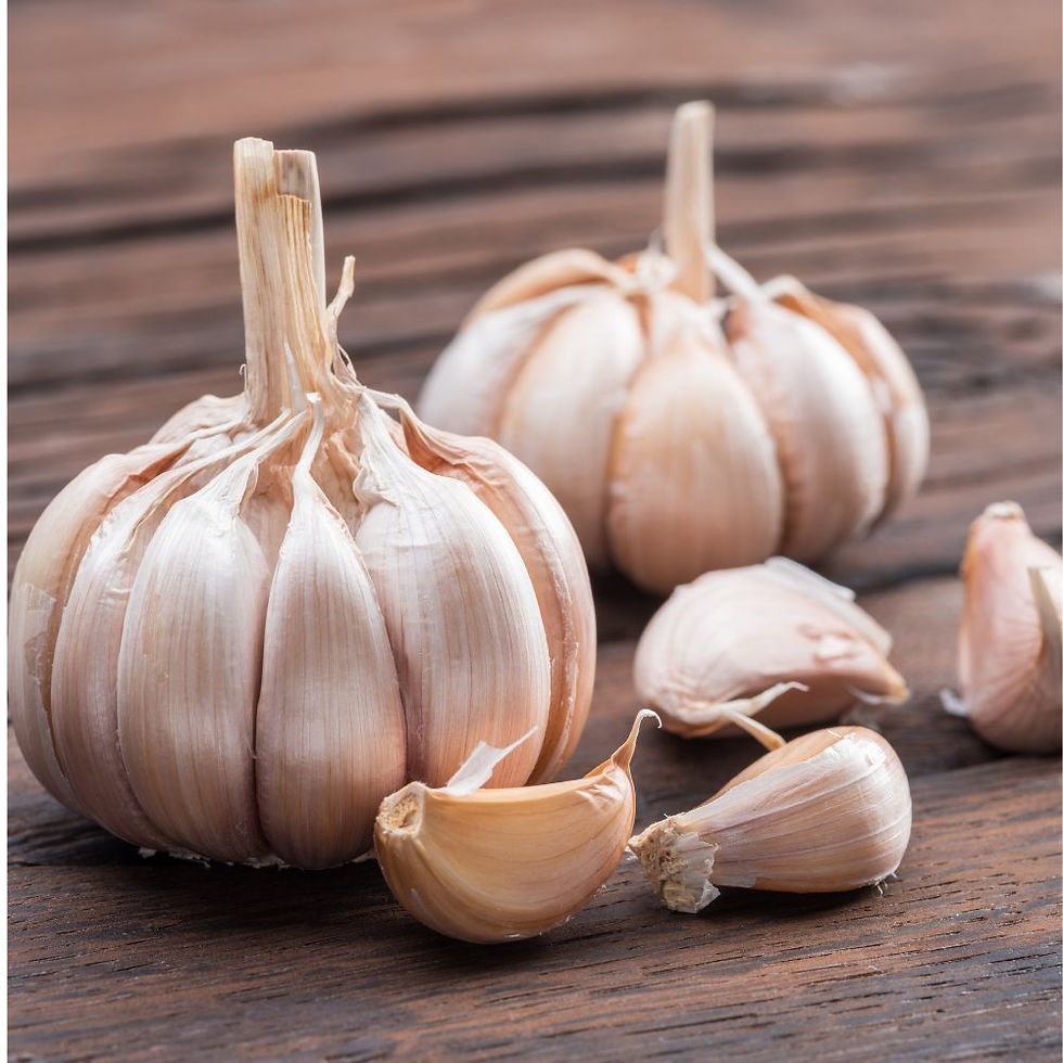 Garlic bulbs and cloves on a wooden surface. The image features natural brown hues and textures, creating a rustic and fresh ambiance.