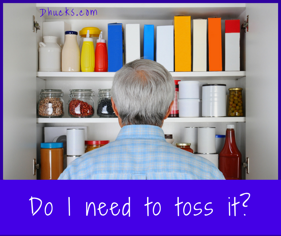 Man looking in pantry cupboard - asking do I need to toss it?