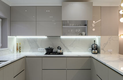 Mid grey handleless kitchen in a modern style and marble look stone benchtops and Blum Aventos lift up overheads