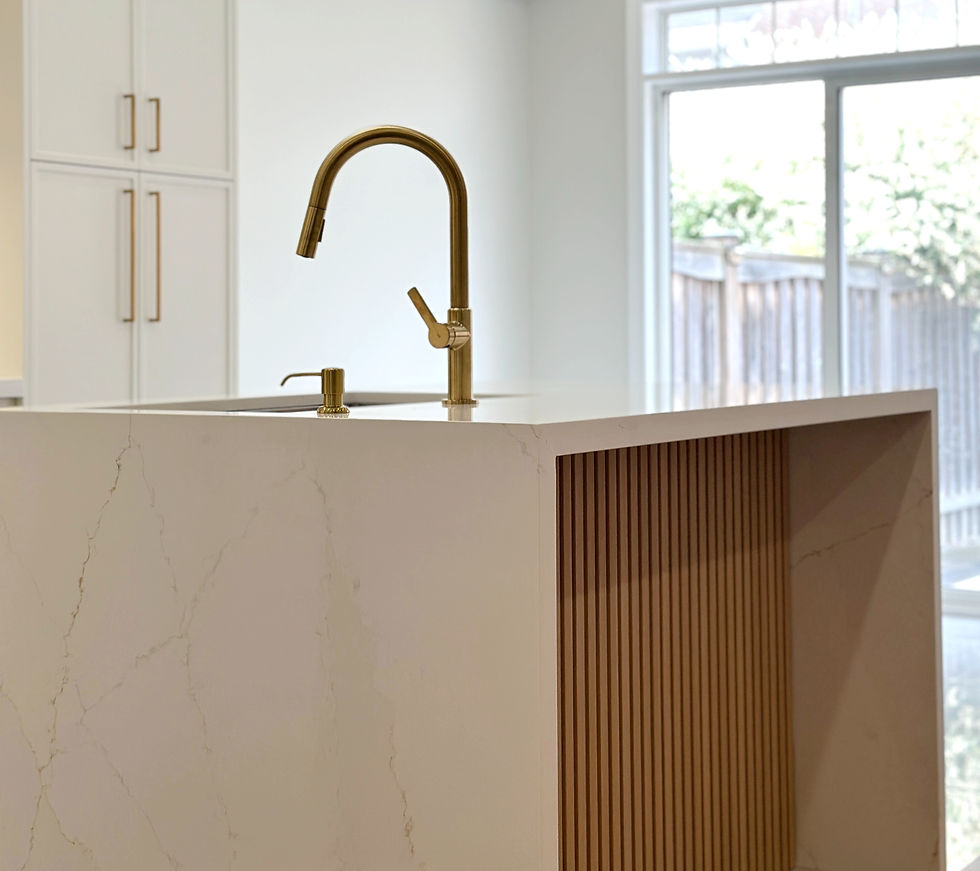 Modern white kitchen with gold hardware designed by StrongRise Builders in York Region, Ontario. Sleek, elegant, and contemporary kitchen design.