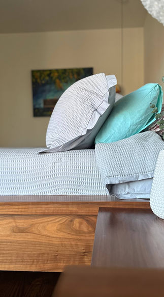 Bedroom with a modern custom-built bed from natural wood, bookmatched design, high-end woodwork, and custom woodwork throughout in York Region, including Thornhill and Vaughan.