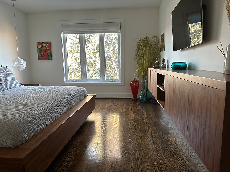 Modern bedroom with custom woodwork and carpentry by StrongRise Builders. Features a custom-built bed, hardwood flooring, and a unique custom storage unit in York Region, Ontario.