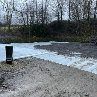 remediating the area where the culvert had been dug out using a weed proof membrane and recycled road planings
