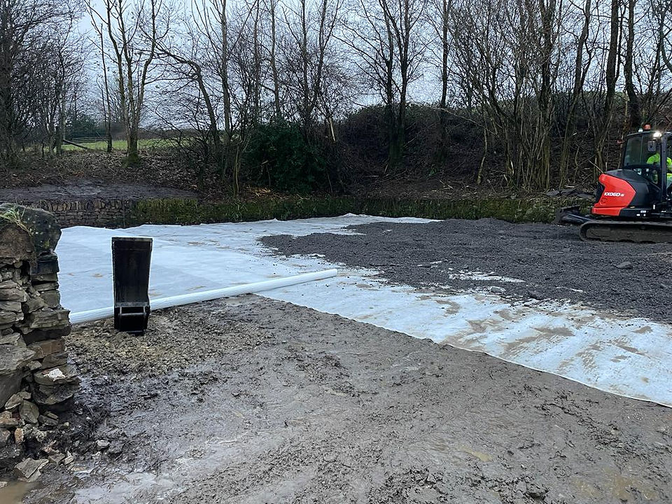 remediating the area where the culvert had been dug out using a weed proof membrane and recycled road planings