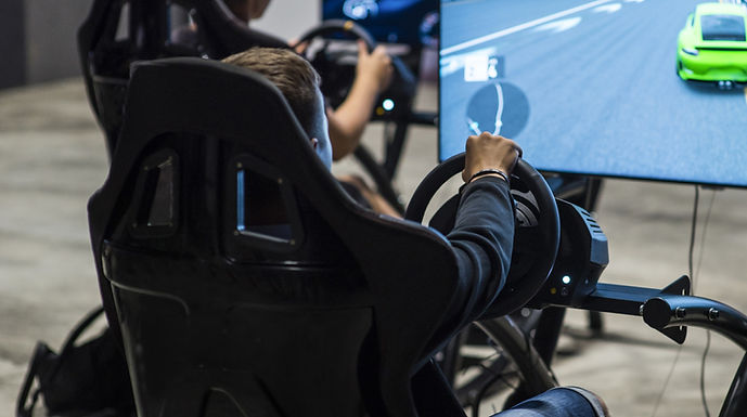 a man driving on a racing simulator