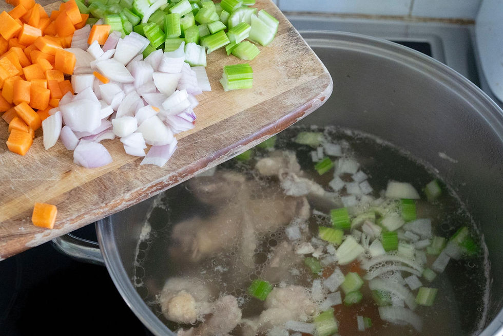 Veggies and chicken bones slow cooked to make homemade bone broth.