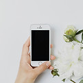 a person holding a cell phone next to a