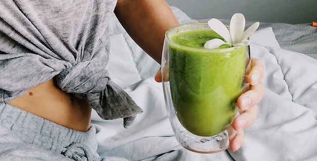 woman-holding-green-smoothie-morning.jpg