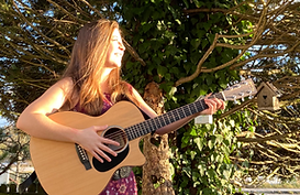 Foto von Carolin Mayer als Musikerin mit Gitarre