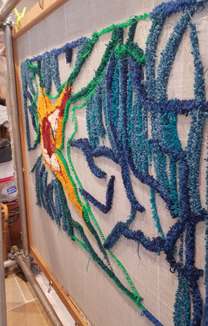 Hazel Tufted Rug by Ryka Design work in progress showing side-angle view of wool loops on reverse linen backing on tufting frame in the artist's studio