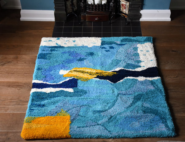 Summer Dive Tufted Rug by Ryka Design displayed in front of Victorian fireplace showing full abstract composition in layered blues, teal, white and golden yellow Axminster wool