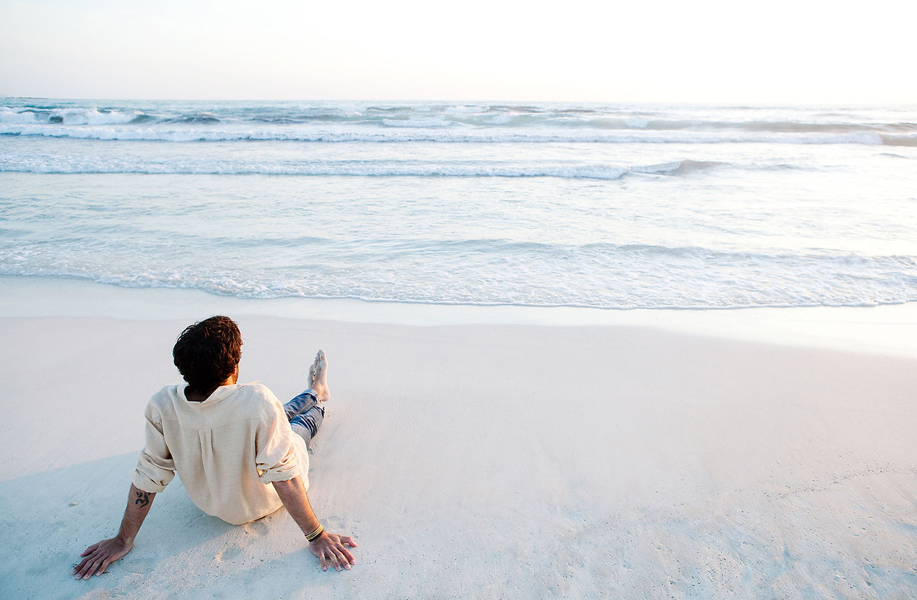 dentist relaxing on beach looking into the ocean contemplating the importance of flossing