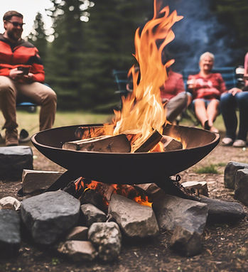 roaring fire burning in a firepit at a campground with people sitting around talking.jpg