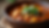 Close-up view of a vibrant jazz-inspired gumbo in a rustic bowl